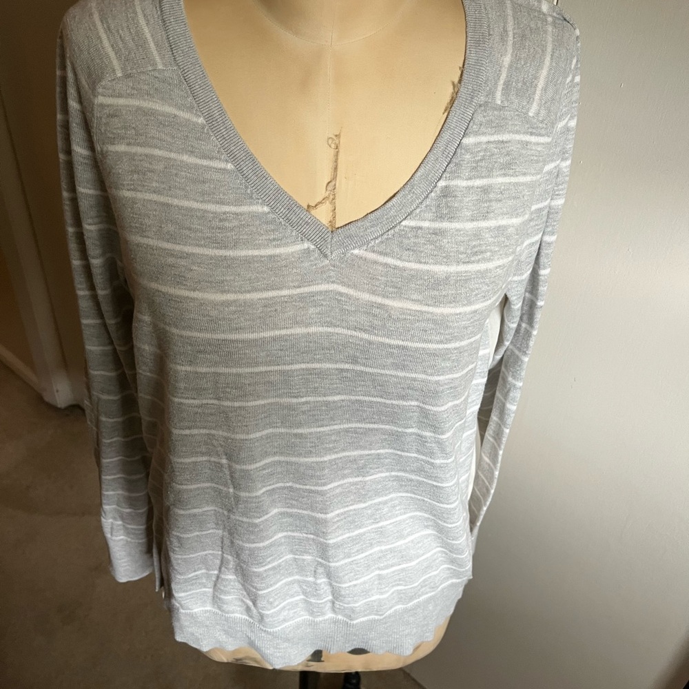 Sheer back.!!. On this v neck gray and white lightweight sweater size m